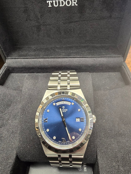 Reeves and Sons Tutor Royal Day Date Diamond Watch model 28600, with gold case, white dial, and diamond accents, 2021.