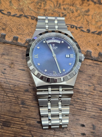 Reeves and Sons Tutor Royal Day Date Diamond Watch model 28600 showing gold case, diamond accents, and day/date display.