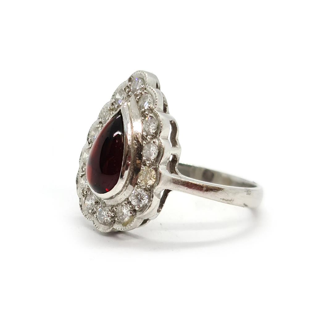 https://shared1.ad-lister.co.uk/UserImages/f9858451-6400-46df-9300-45516e64c4e1/Img/Diamondrings/18ct-white-gold-160-crt-Garnet--060-crt-diamond-ring-p1.jpg