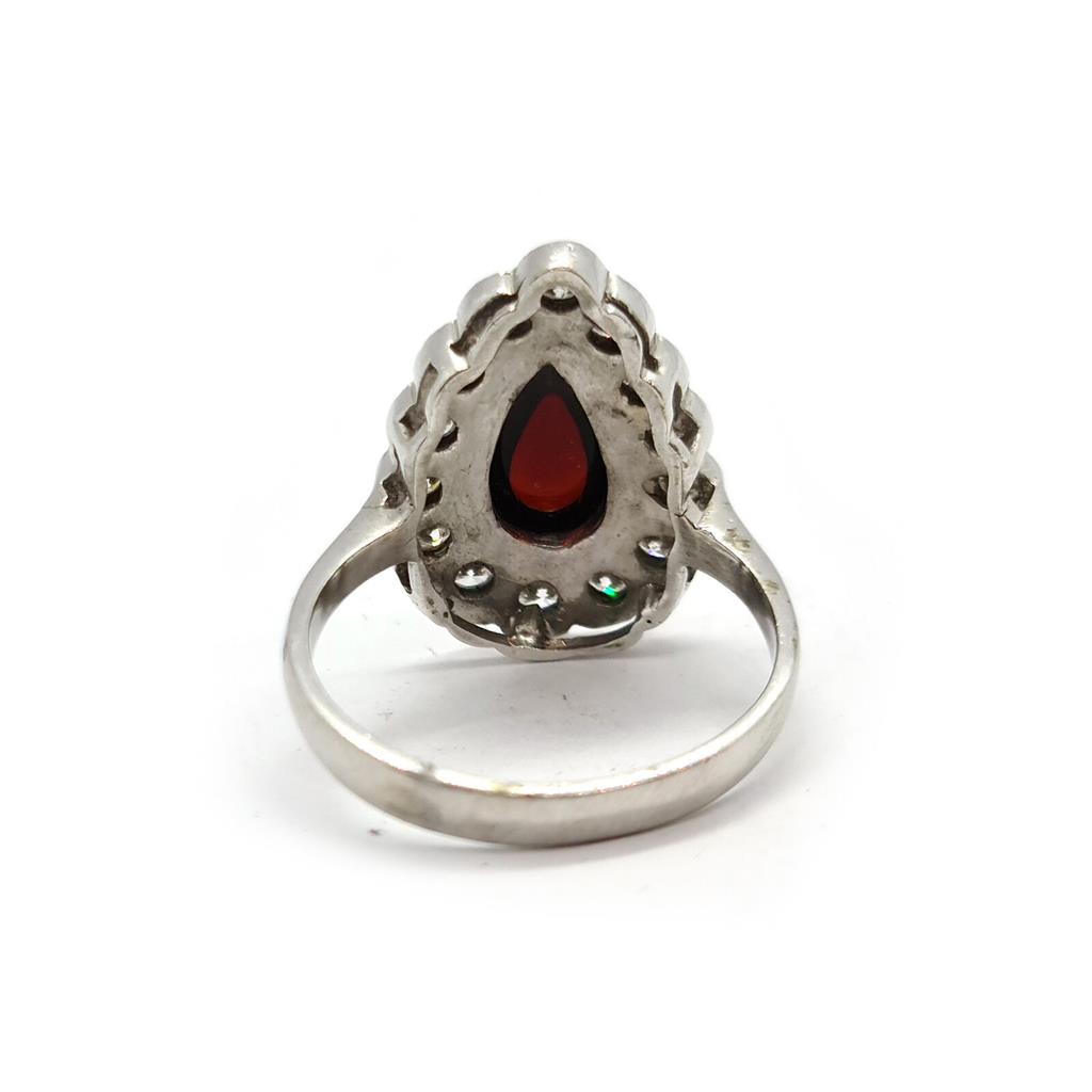 https://shared1.ad-lister.co.uk/UserImages/f9858451-6400-46df-9300-45516e64c4e1/Img/Diamondrings/18ct-white-gold-160-crt-Garnet--060-crt-diamond-ring-p3.jpg