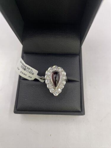 https://shared1.ad-lister.co.uk/UserImages/f9858451-6400-46df-9300-45516e64c4e1/Img/Diamondrings/18ct-white-gold-160-crt-Garnet--060-crt-diamond-ring-p6.jpg